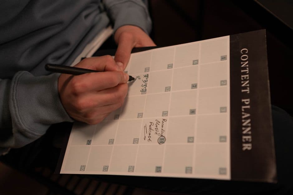 Person planning habits and goals on a calendar