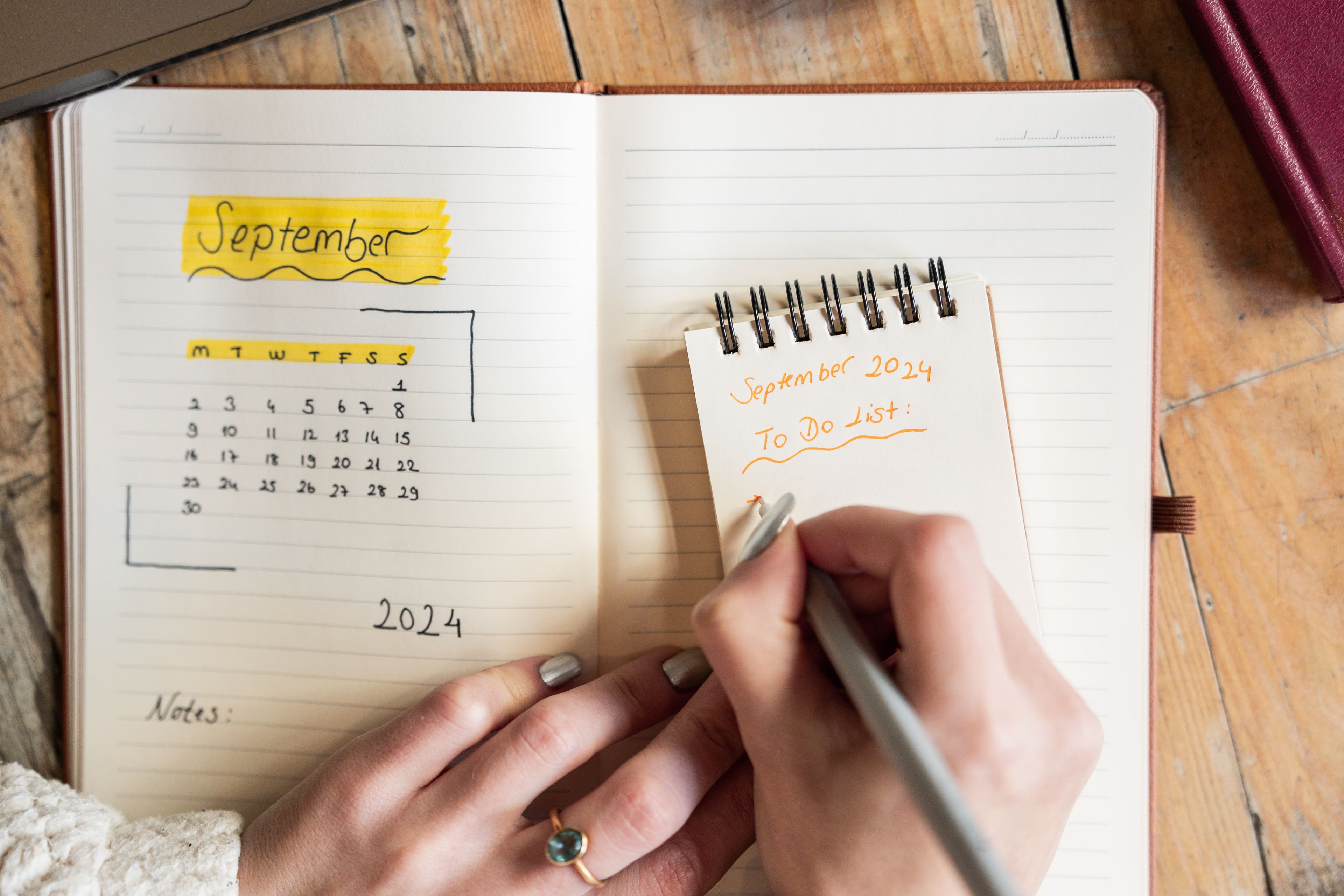 Person writing to-do list on paper