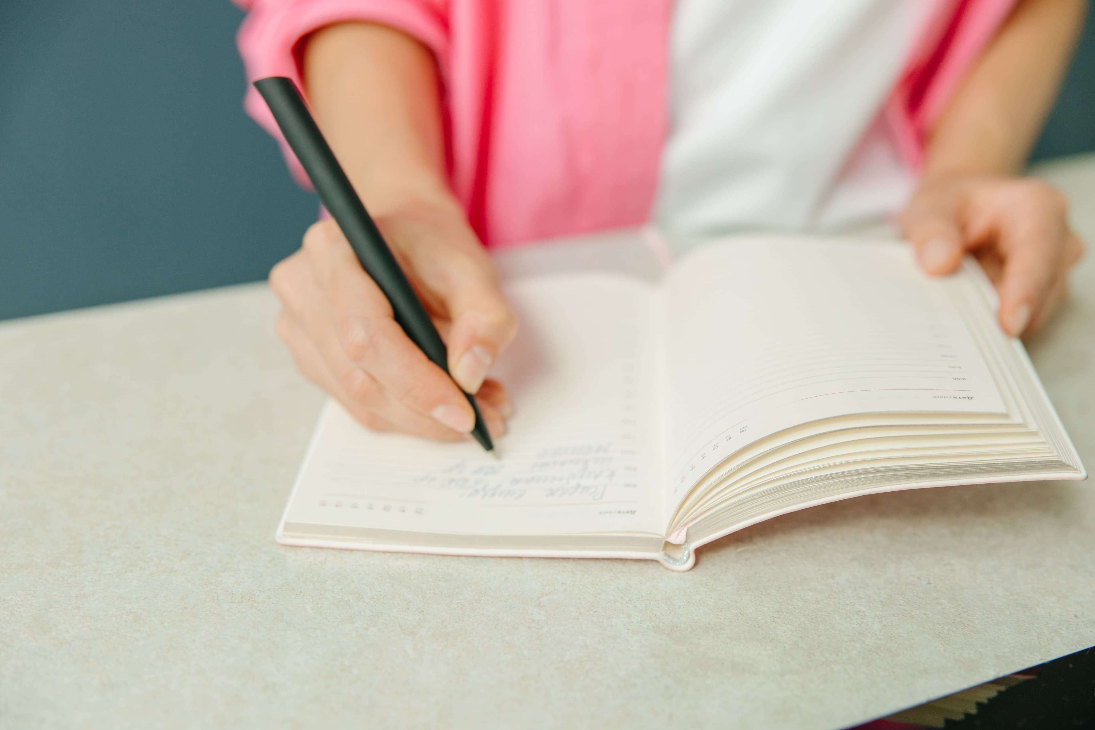 Person planning habits in a notebook