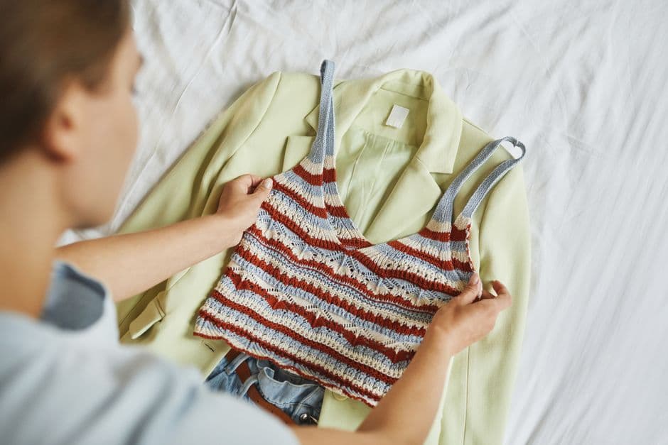 Person organizing clothes as part of preparing a routine