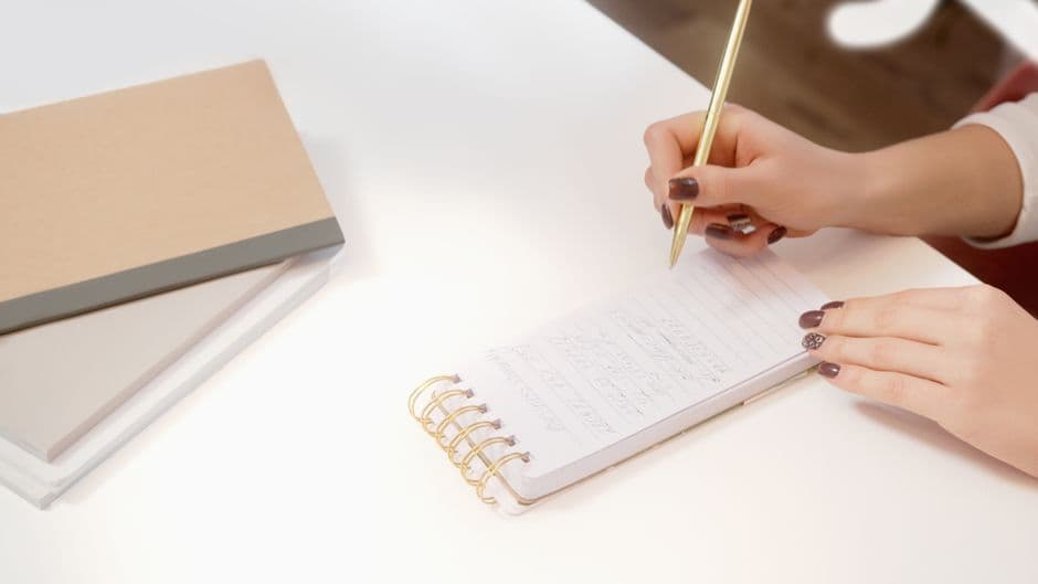 Person writing a plan for restarting a habit