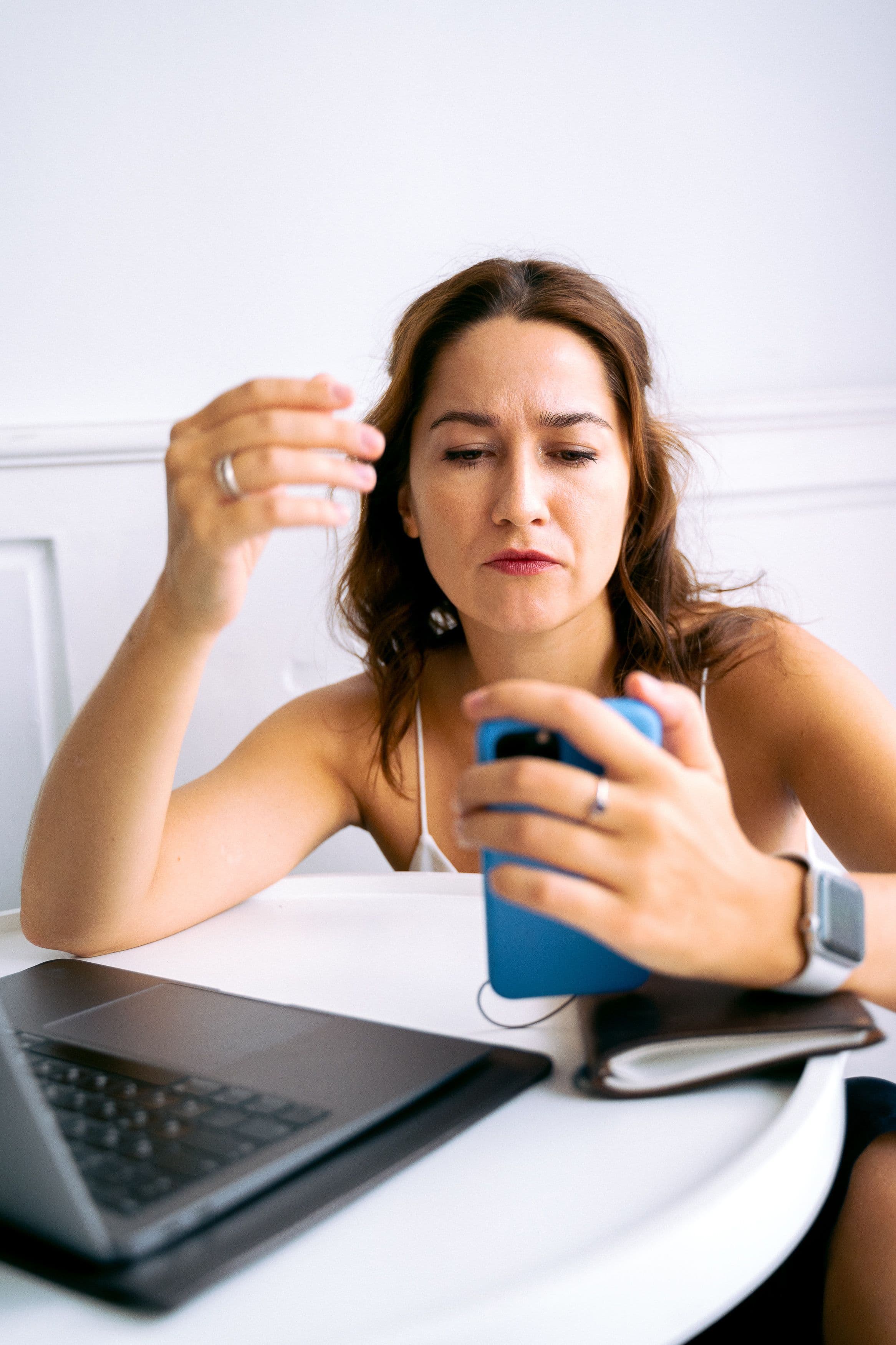 Frustrated person putting down phone with habit tracker app
